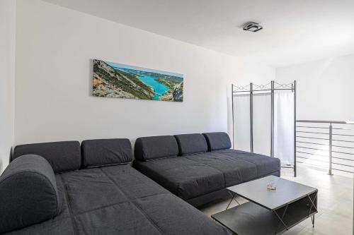 a living room with a couch and a table at Beautiful renovated 4P1BR apartment with view on garden in Antibes