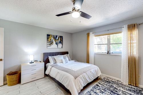 a bedroom with a bed and a ceiling fan at Port of Call in Port Charlotte