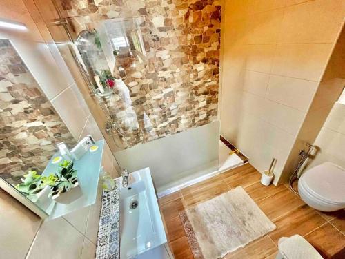a bathroom with a shower with a toilet and a sink at Cozy appartament sea view in Marsaskala