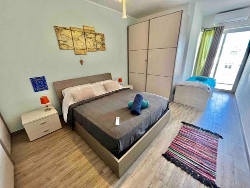 a bedroom with a bed with a blue teddy bear on it at Cozy appartament sea view in Marsaskala