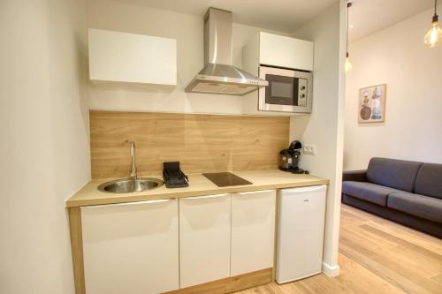 坎城的住宿－Elégant Studio moderne Wifi Proche suquet - LIMESTAY，一间带水槽和沙发的小厨房