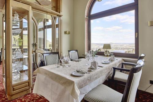 a dining room with a table and a large window at Hohenzollern in Bad Neuenahr-Ahrweiler