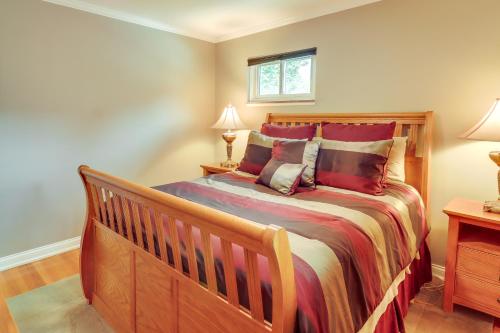 a bedroom with a large wooden bed with red pillows at Royal Oak Home 13 Mi to Downtown Detroit in Royal Oak