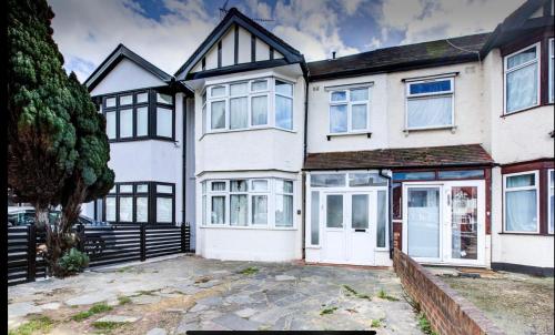a large white house with black trim at Modern private Double en-suite room2 in Barkingside
