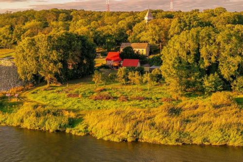 a house on a hill next to a river at OderPoint#Sauna#Jacuzzi in Gozdowice