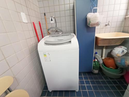 a bathroom with a sink and a small refrigerator at Ap Brisa do Mar Praia da Costa in Vila Velha