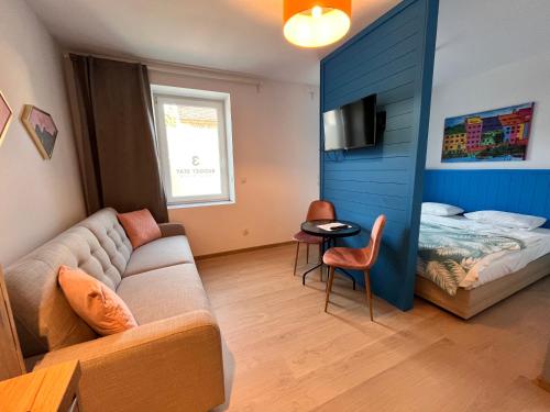 a living room with a couch and a bed at 3 Budget Stay Apartments in Zgorzelec