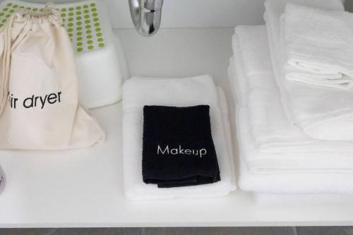 a bathroom counter with white towels and other items at Bright Top Floor-Elevator-Walk Downtown-Laundry in Walnut Creek