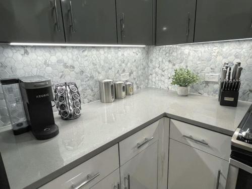 a kitchen with white cabinets and a counter top at Bright Top Floor-Elevator-Walk Downtown-Laundry in Walnut Creek