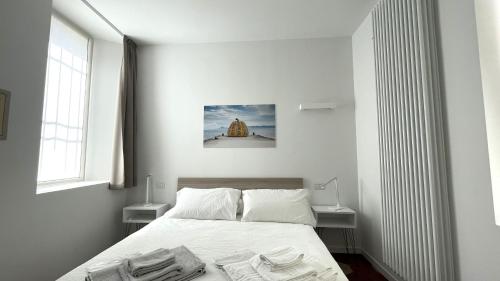 a bedroom with a bed with towels on it at Santa Vincenza - Suite Indipendente in Lovere