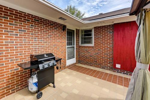 a brick patio with a grill and a red door at Pet Friendly Home with Hot Tub, Patio and Game Room! in Clayton
