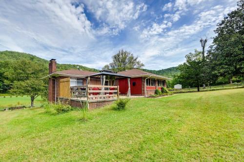 a red house in the middle of a field at Pet Friendly Home with Hot Tub, Patio and Game Room! in Clayton