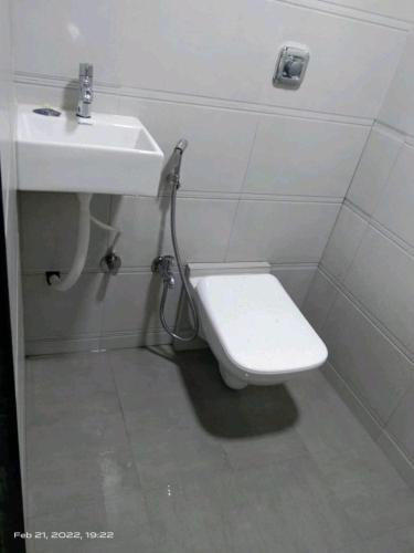 a bathroom with a toilet and a sink at Marol dormitory in Mumbai