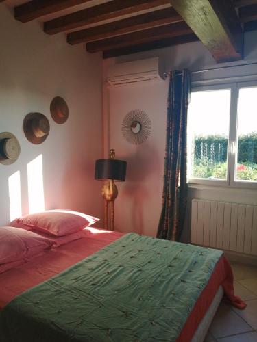 a bedroom with a bed and a window at Chambre d'hôtes Les moutons bleus in Le Tronquay