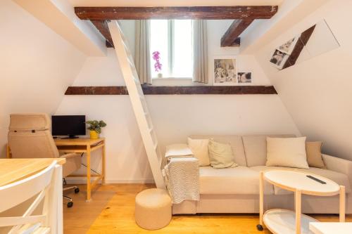 a living room with a couch and a desk at Charming Loft City Center in Copenhagen