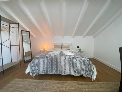 a bedroom with a large bed in a white room at Grândola Suites - Suite Loft in Grândola