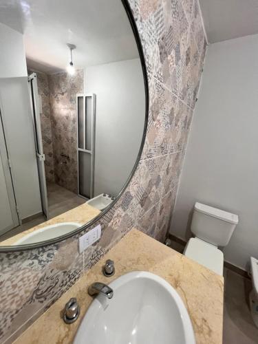 a bathroom with a sink and a mirror at Mono ambiente de lujo en San Miguel de tucuman in San Miguel de Tucumán