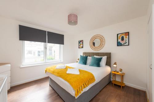 a bedroom with a large bed and a window at Ground Floor 2 Bed Flat Slateford in Edinburgh