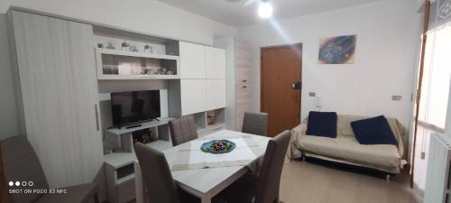 un soggiorno con tavolo e divano di Da Serraona appartamento ad Alghero ad Alghero