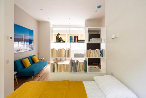 a bedroom with a bed and a book shelf with books at Artist's Studio in Stockbridge in Edinburgh