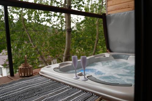 a bath tub sitting on a deck with two utensils at Parádka - Toscana Villa in Parád