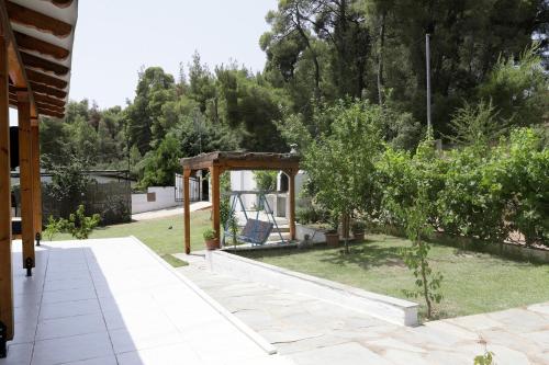 a garden with a playground and a gazebo at Dimitra House in Metamorfosi