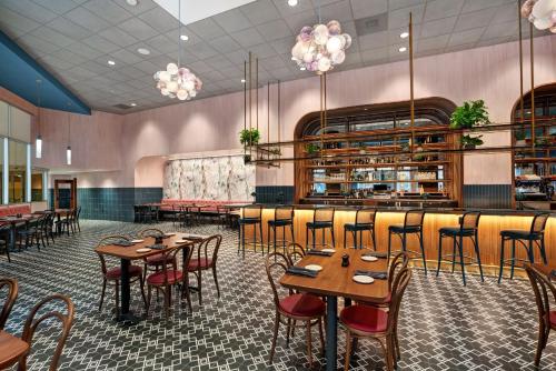 a restaurant with tables and chairs and a bar at Hotel Indigo - Minneapolis Downtown by IHG in Minneapolis