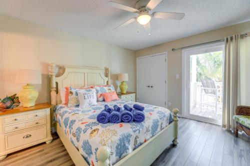 a bedroom with a bed and a ceiling fan at Emerald Isle Condo with Indoor Pool and Beach Access! in Emerald Isle