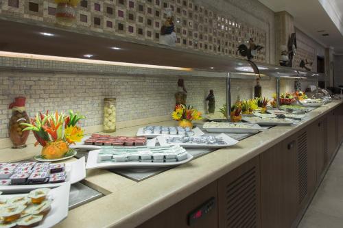 a buffet line with plates of food on display at Gurkent Hotel in Ankara