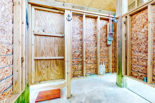 una casa en construcción con puerta de garaje de madera en Cap'n Stilts, en Hatteras