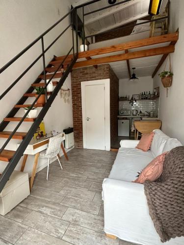 a living room with a staircase and a white couch at Loft en Las Flores in Las Flores