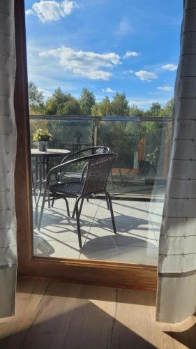 a chair on a porch with a view of a patio at Apartament Poleska Park in Częstochowa