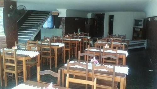 a group of tables and chairs in a room at Pousada do Goiano in Cabo Frio