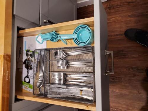 a drawer filled with utensils in a refrigerator at The Cozy Caribou - Frontier Village in North Pole