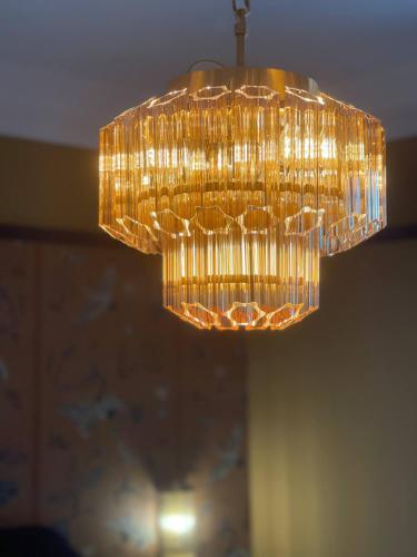 a large gold chandelier hanging from a ceiling at The Bedford Inn in Ramsgate