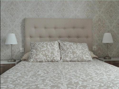 a bedroom with a large bed with two lamps at La Casita de Daise in Garachico