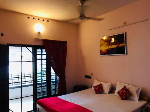 a bedroom with a bed and a window with a view at OCEAN PEARL RESIDENCY in Cochin