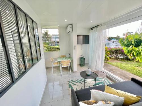 a living room with a couch and a table at Appartement Belbo de la Marina in Les Trois-Îlets