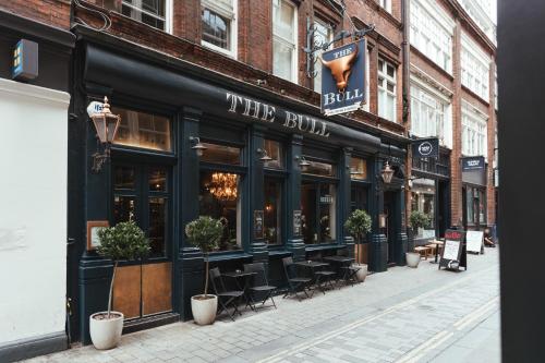 a store front of a building on a city street at The Bull and The Hide in London