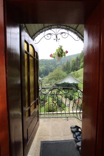 an open door to a balcony with a view at Котедж "Красний Краєвид" in Yaremche