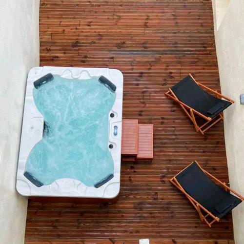 a swimming pool on a table with two chairs at La Romance à Bulles en Hyper Centre in La Rochelle
