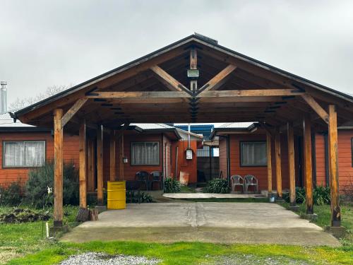 a house with a large wooden pavilion in front of it at Vista Alegre in Parral
