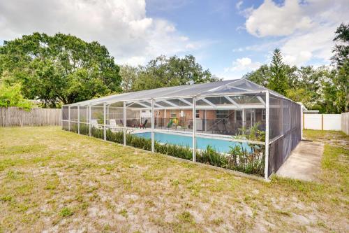 a greenhouse with a pool in a yard at Pet-Friendly Lakeland Escape with Private Pool! in Lakeland