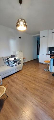 a living room with a white couch and a table at Apartament z tarasem Kutno in Kutno
