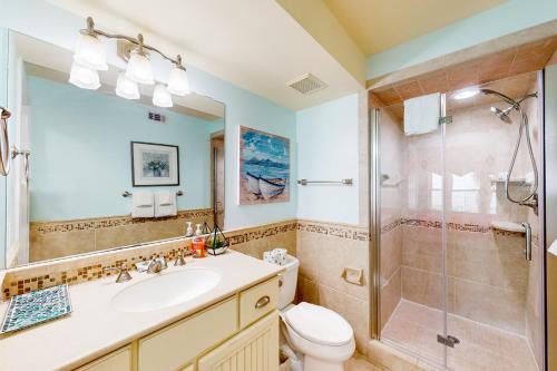 a bathroom with a toilet sink and a shower at Tybee T's Chu Beach Condo in Tybee Island