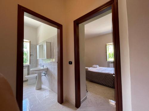 a bathroom with a sink and a toilet and a tub at Villa con Piscina Donna Romina in SantʼAgata deʼ Goti