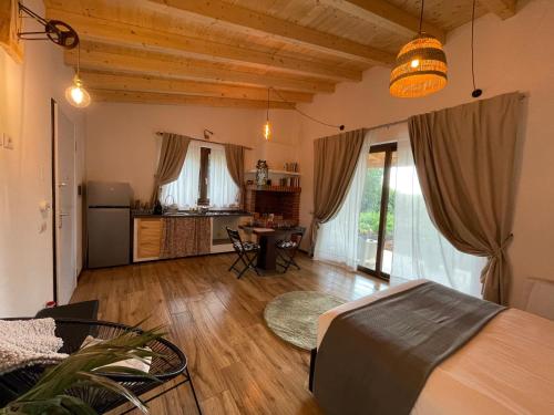 a living room with a bed and a dining room at La Marmotta COUNTRY RELAIS sul lago in Anguillara Sabazia