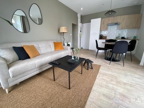 - un salon avec un canapé et une table dans l'établissement Myaka©Appartement Fontana, à Cholet