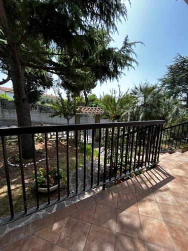 a black fence with a tree in the background at B&B la casa di Polly in Falconara Marittima