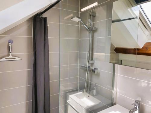 a bathroom with a shower with a toilet and a sink at La Noé d'Or by Madame Conciergerie in Bruz